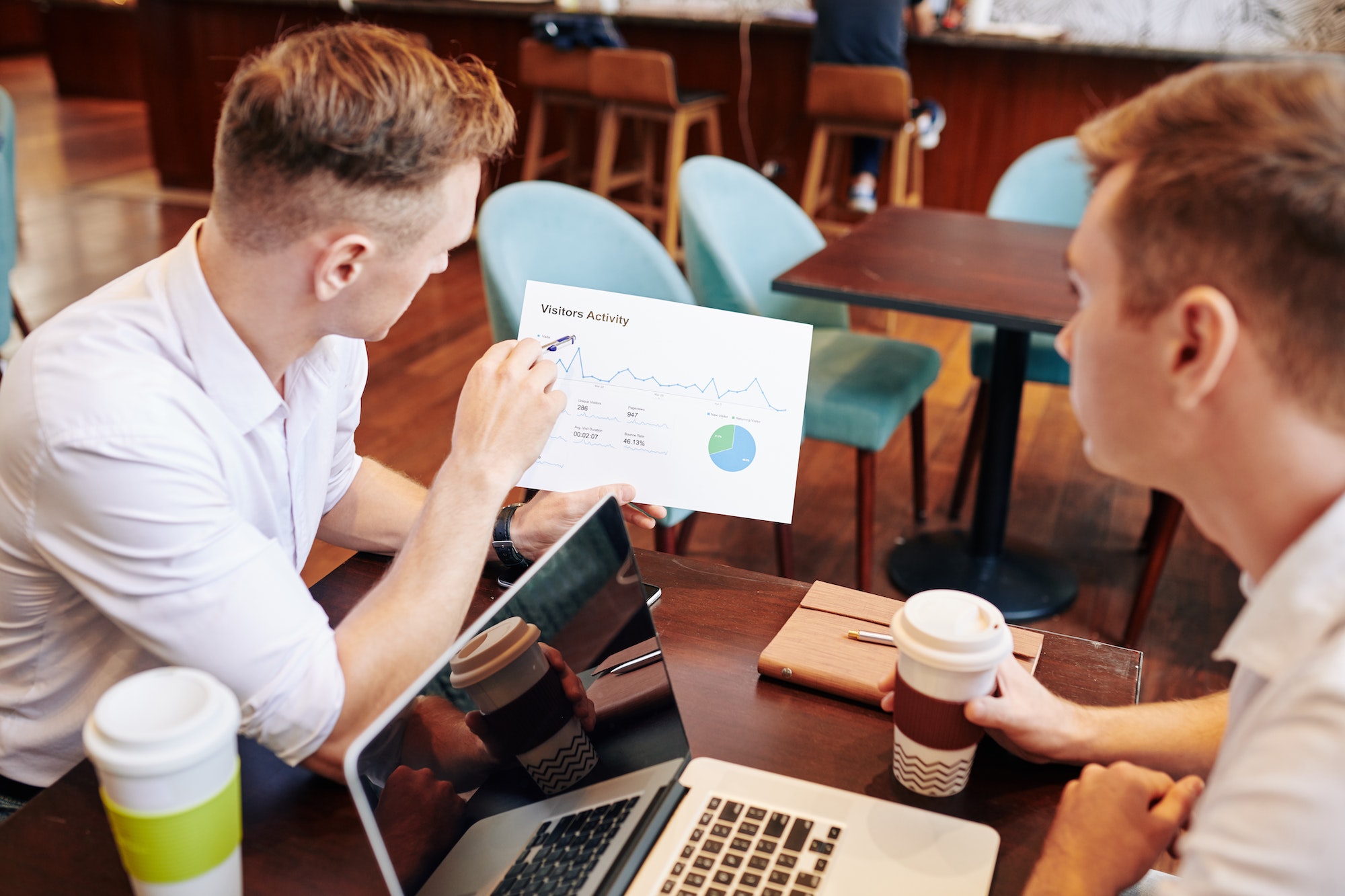 Marketing manager showing document to colleague